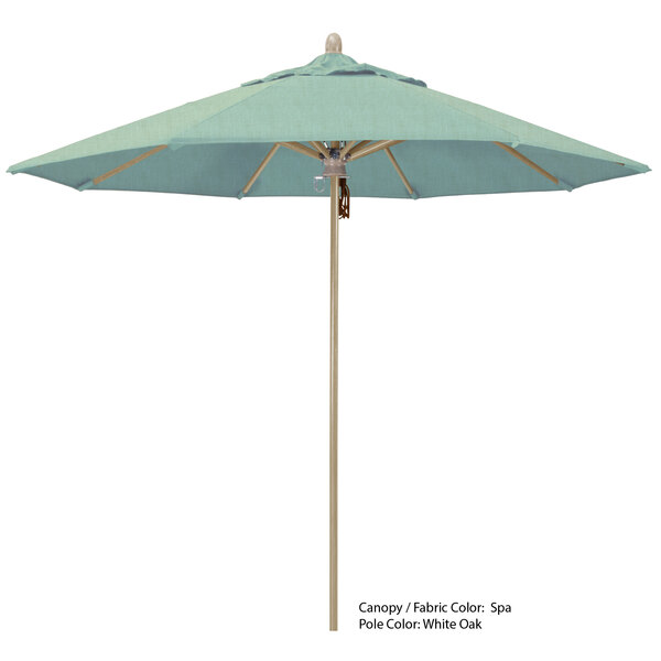 A close-up of a blue California Umbrella with a wooden pole.