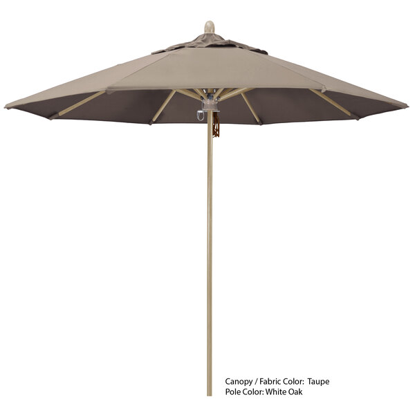 A close-up of a California Umbrella with a beige Sunbrella canopy and a wooden pole.