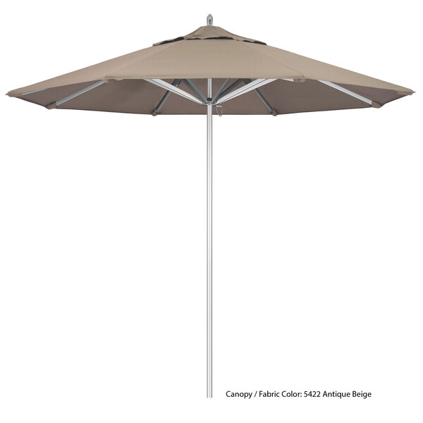 A close-up of a beige California Umbrella with a Sunbrella canopy on a white pole.