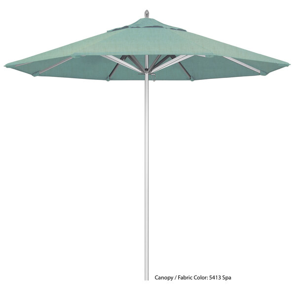 A California Umbrella with a blue Sunbrella canopy and a white pole.