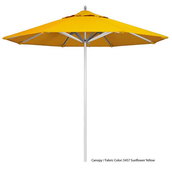 A close up of a yellow California Umbrella with a white pole.
