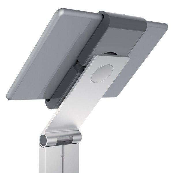 A silver metal floor stand tablet holder with a tablet on it.