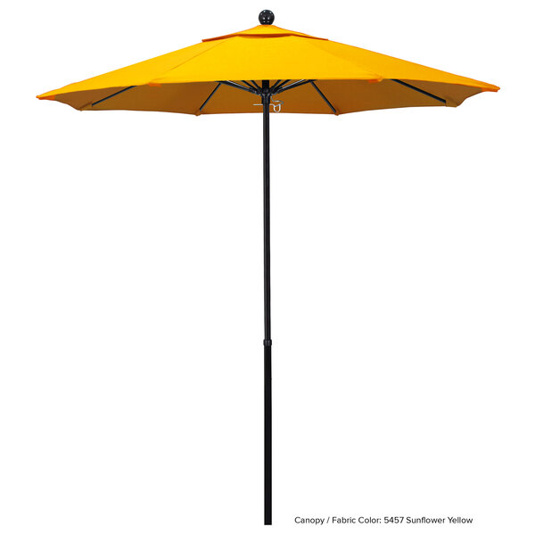 A yellow California Umbrella with a Sunbrella Oceanside canopy on a black pole.