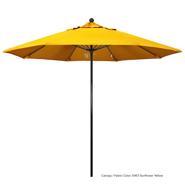 A close up of a yellow California Umbrella with a black pole.