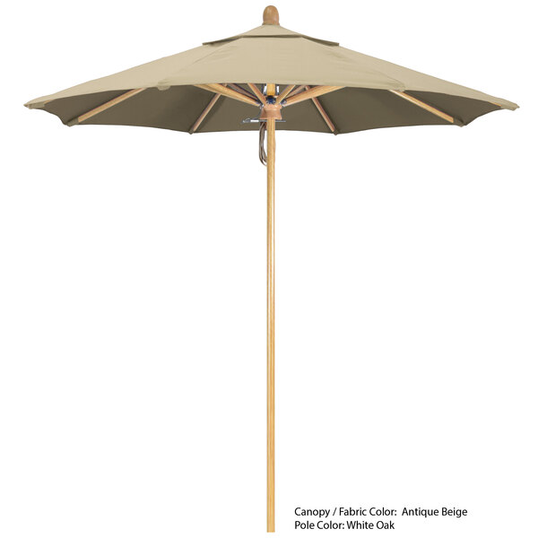 A close-up of a tan California Umbrella with a wooden pole.