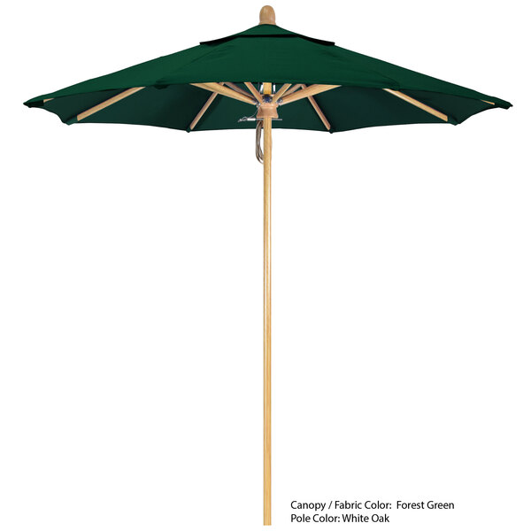A green California Umbrella with a wooden pole.