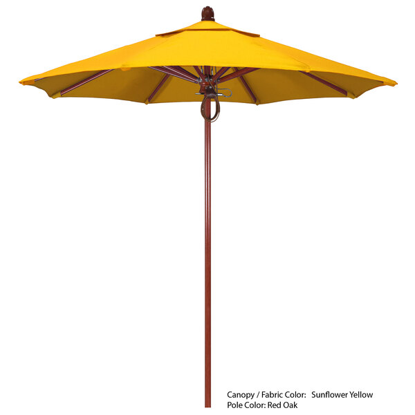 A yellow California Umbrella with a wooden pole on a white background.