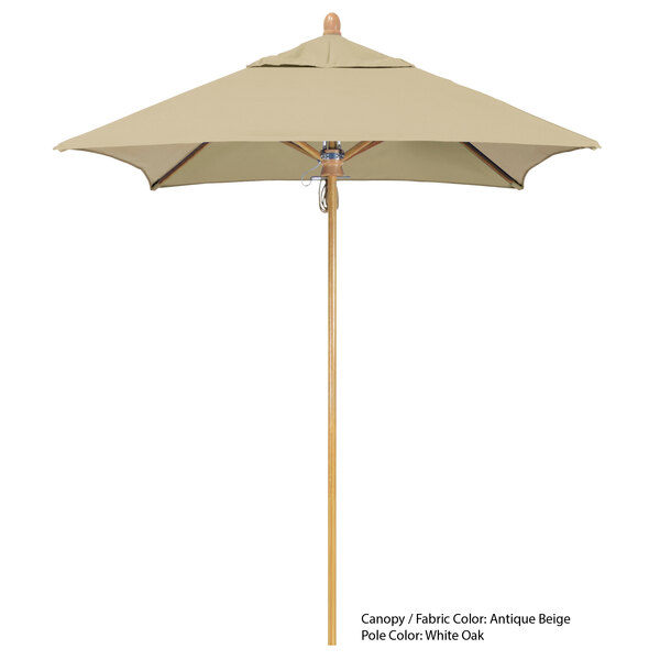 A California Umbrella Sierra Sunbrella umbrella with a beige canopy and a wooden pole.