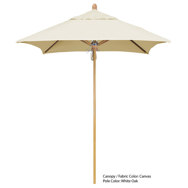 A close-up of a California Umbrella with a white Sunbrella canopy and a wooden pole.
