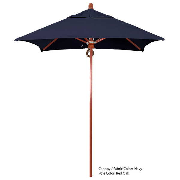 A blue California Umbrella with a wooden pole and a blue Sunbrella canopy.