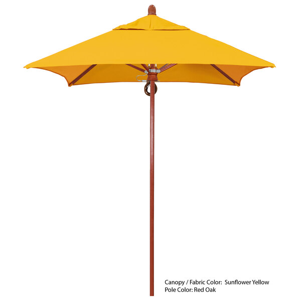 A yellow California Umbrella with a wooden pole.