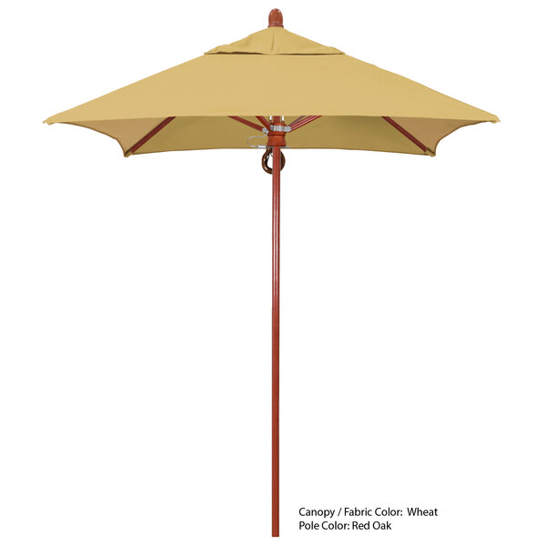 A California Umbrella with a yellow Sunbrella canopy on a wooden pole.