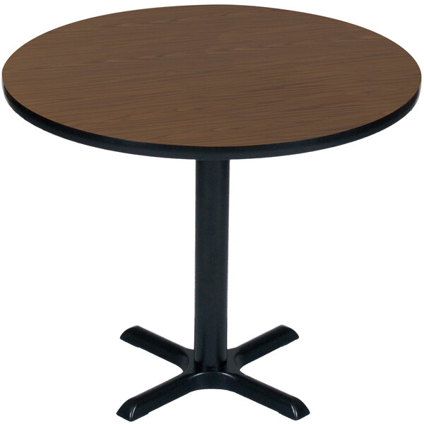 A Correll round table with a black base and a walnut top.