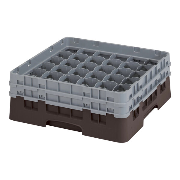 A grey and brown plastic container with several compartments and holes.