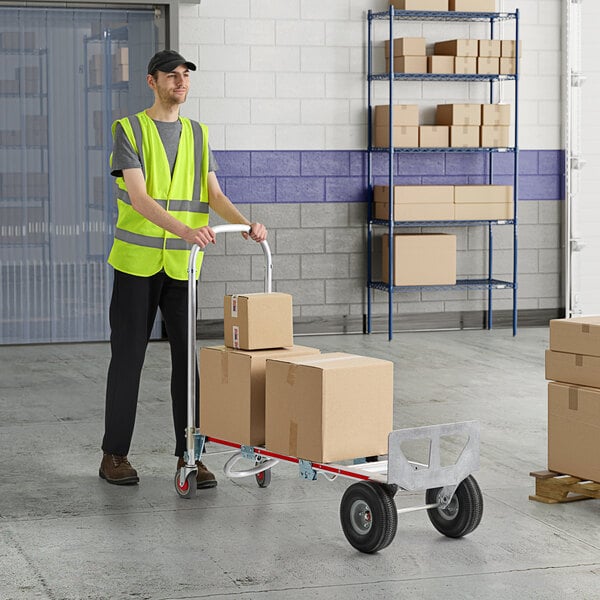 A man pushing a Magliner hand truck with boxes on it.