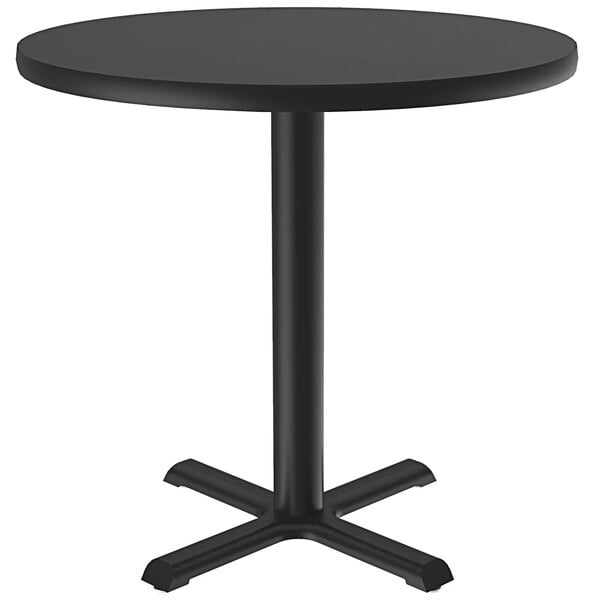 A Correll black granite round table on a metal base.