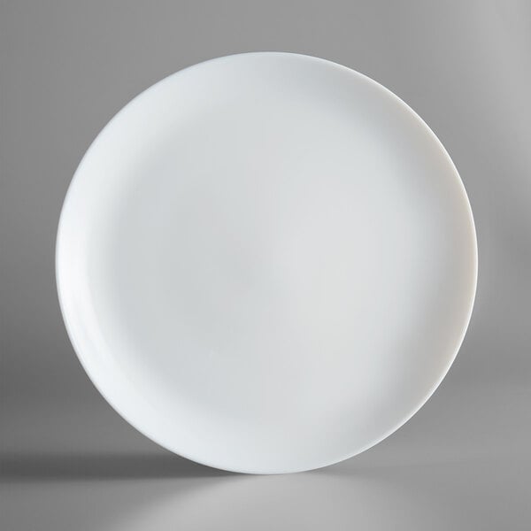 A close up of an Arcoroc white round rimless opal glass plate.