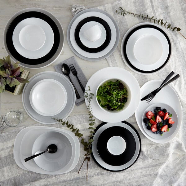 A table set with Arcoroc white glass plates and bowls.