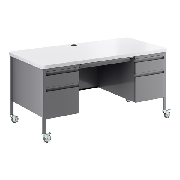 A mobile double pedestal teacher's desk with a white top and platinum gray base, featuring multiple drawers and caster wheels.