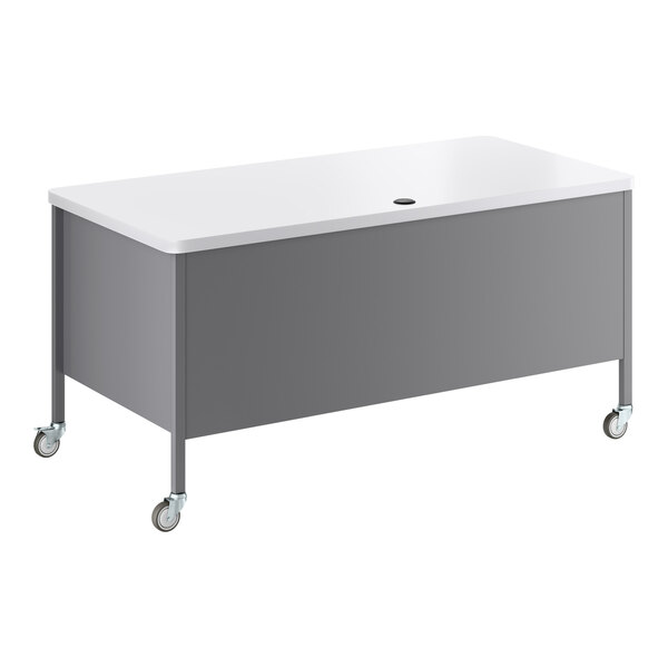 A mobile double pedestal teacher's desk with a white top and platinum-colored base, featuring four caster wheels.