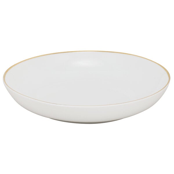 A white porcelain soup bowl with gold rim.