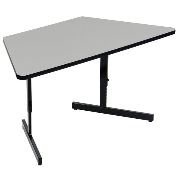 A grey trapezoid table with black legs.