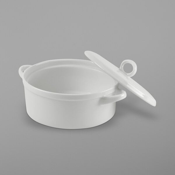 A white round porcelain baker with a lid.