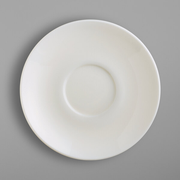 A white saucer with a circle in the middle.