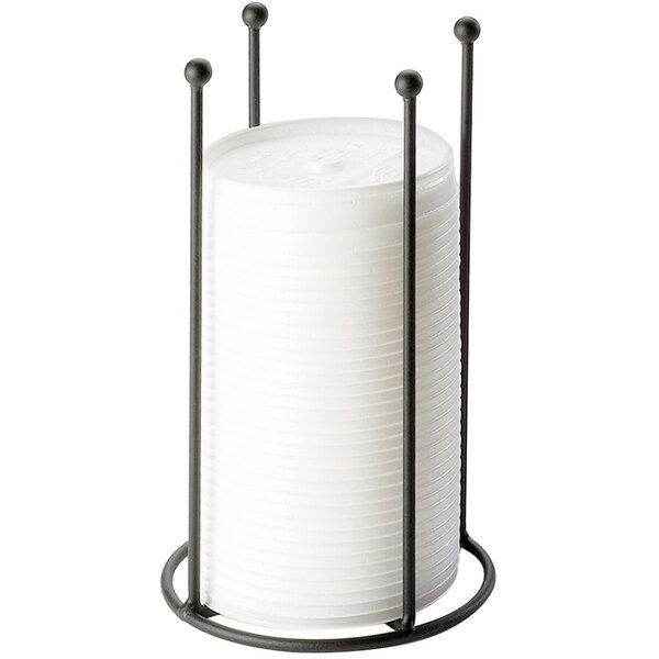 A black metal Cal-Mil countertop organizer with white cylinders on top.