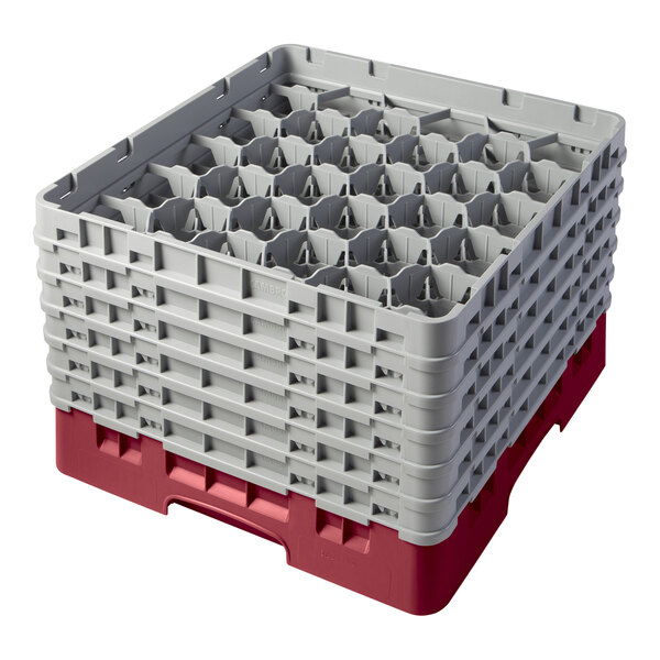 A cranberry plastic Cambro glass rack with compartments.