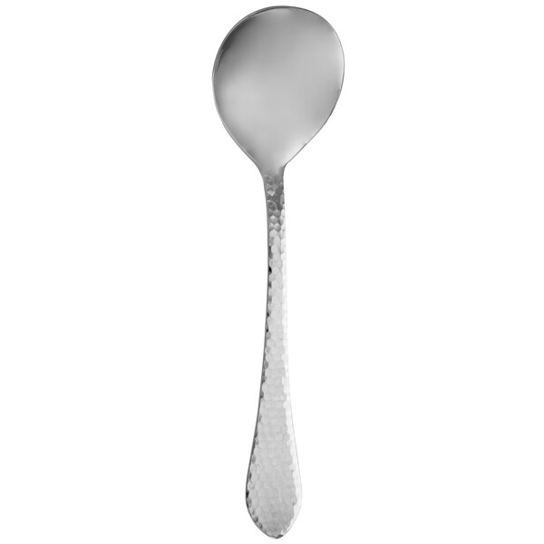 A close-up of a Walco stainless steel hammered serving spoon with a white background.