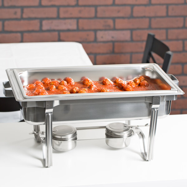 A Vollrath stainless steel steam table water pan with food in it.