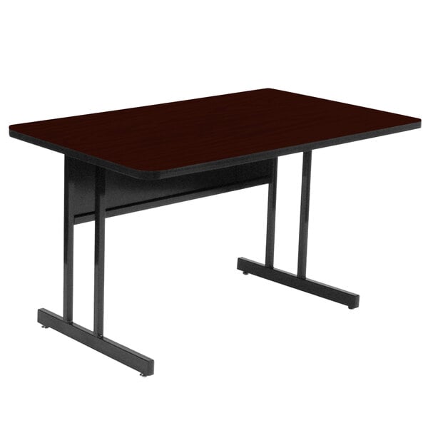 A rectangular mahogany desk with black metal legs.