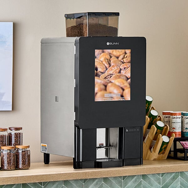 A black and stainless steel Bunn Sure Immersion 312 single cup coffee brewer with a digital display, placed on a countertop.