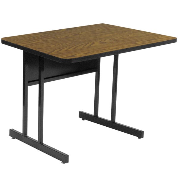 A brown rectangular Correll desk with black legs.