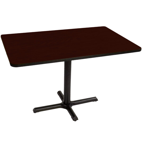 A rectangular mahogany table with a black base.