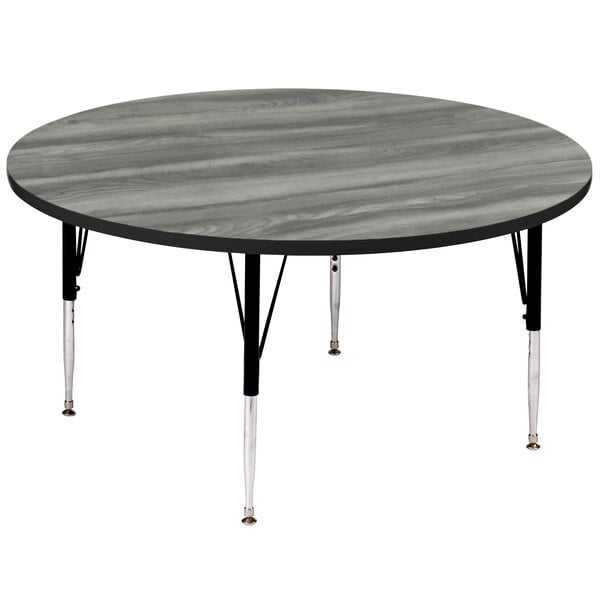 A Correll round activity table with adjustable black legs and a gray top.