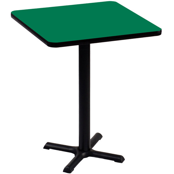 A green Correll square table with a black base.