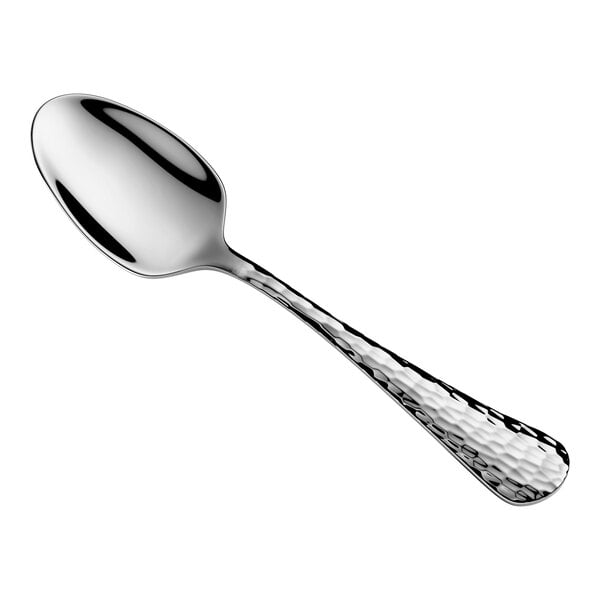 A metal teaspoon with a hammered texture on the handle and a smooth, reflective bowl.