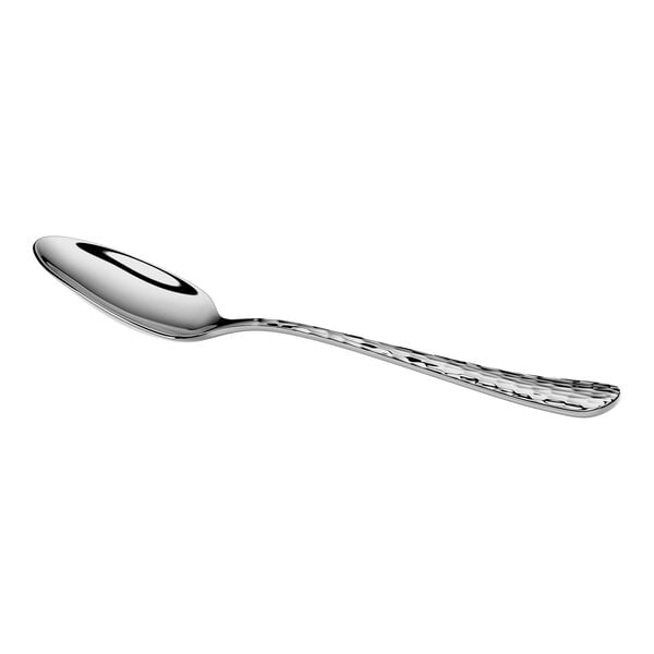 A shiny metal teaspoon with a textured handle is shown against a white background.