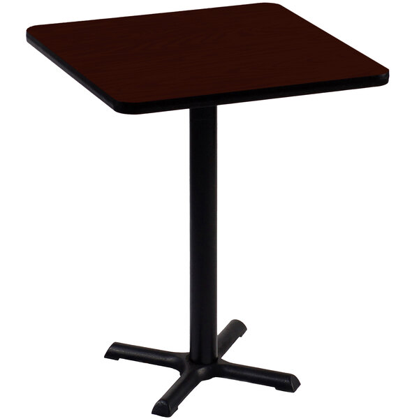 A Correll bar height table with a black base and mahogany top.
