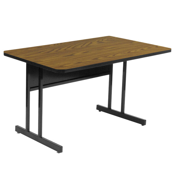 A brown rectangular Correll desk with black legs.