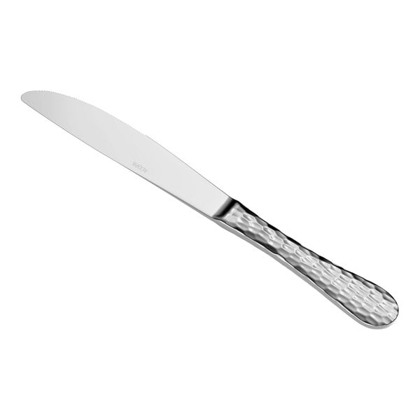 A stainless steel dinner knife with a textured handle and a smooth, slightly serrated blade.