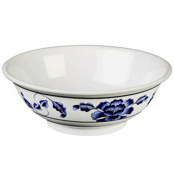 A white Thunder Group melamine bowl with blue flowers on it.