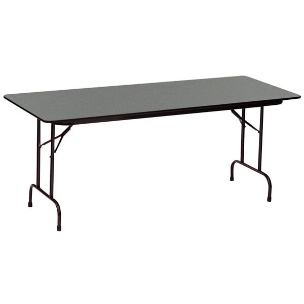 A black rectangular Correll folding table with metal legs and a black Montana granite finish.