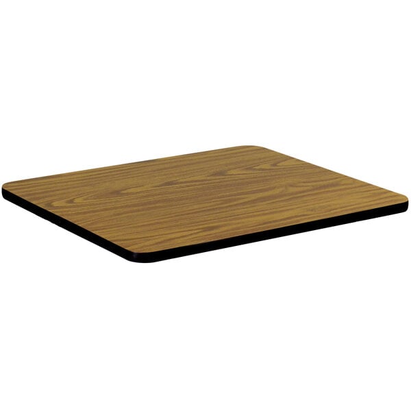 A medium oak rectangular table top with a wood surface and black edges.