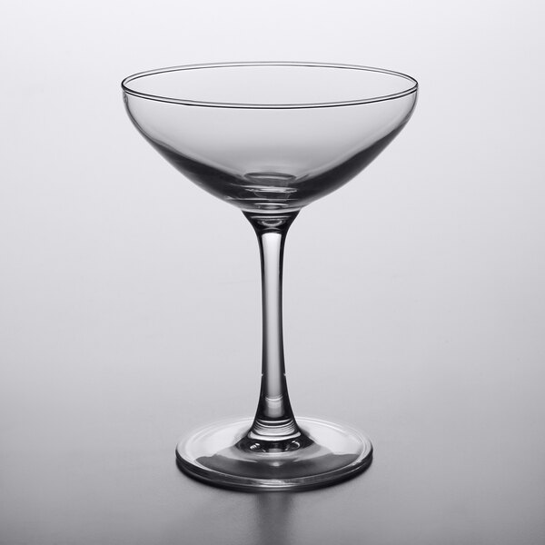 An Arcoroc clear wine glass with a stem.