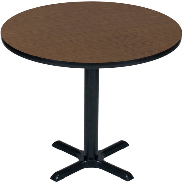 A Correll round table with a walnut top and a black base.