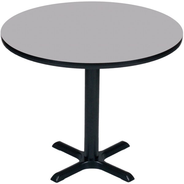 A Correll round bar height table with a gray granite finish top and a black base.