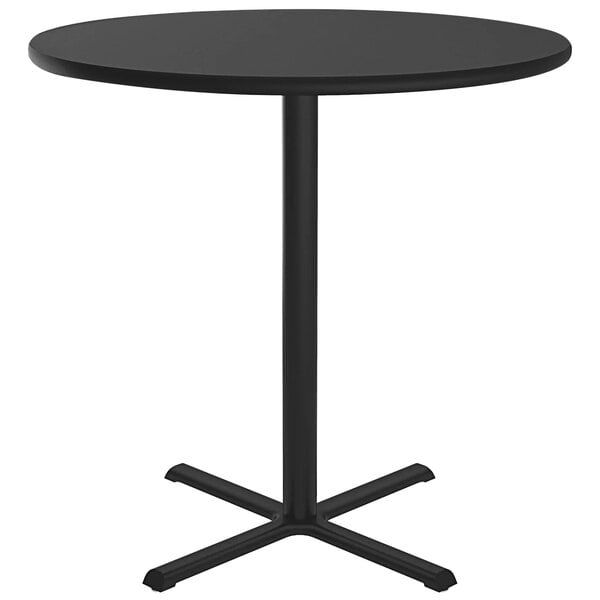 A Correll black bar height table with a metal base and round top.